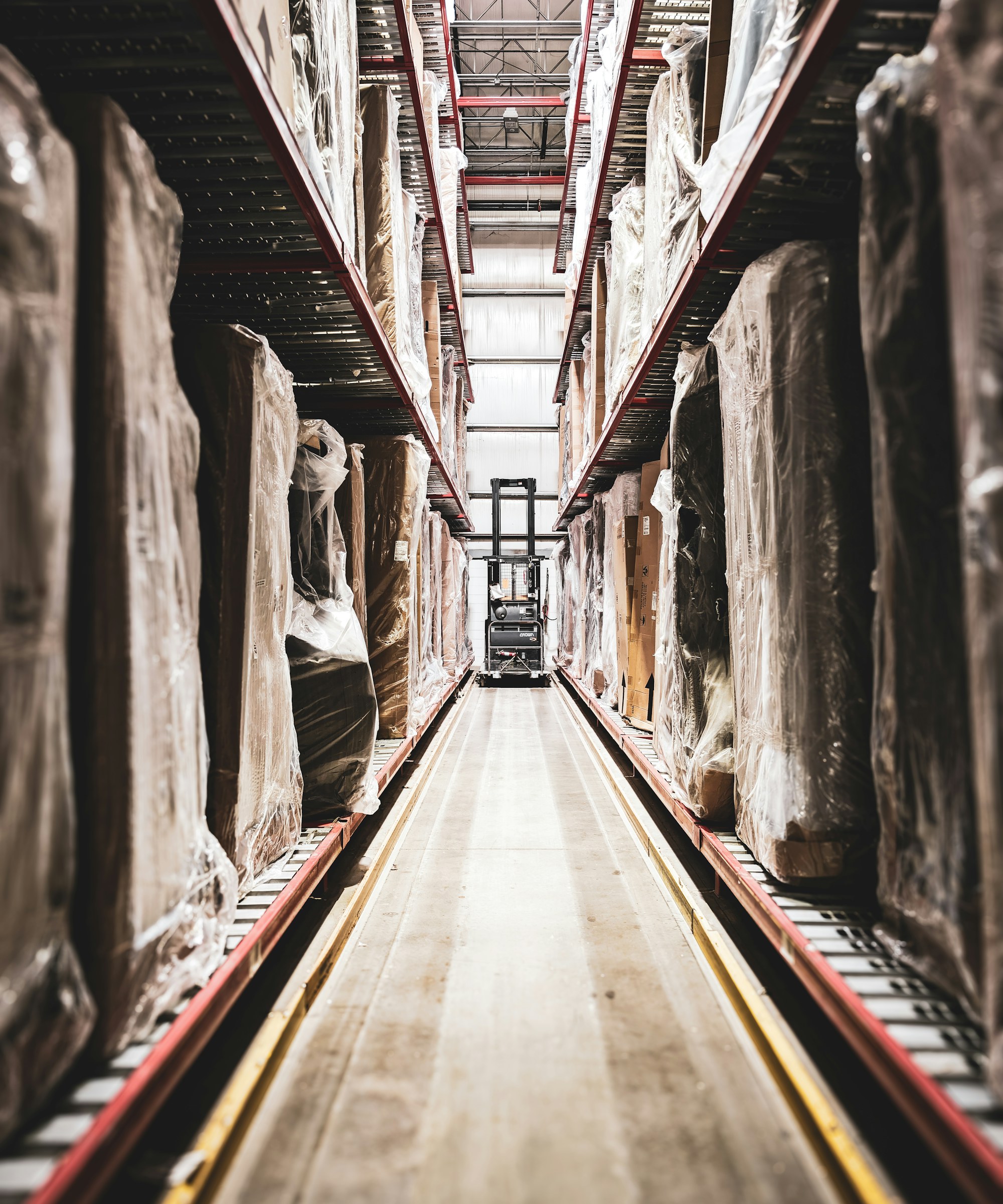 A distribution warehouse with pallet racking stacked with cartons