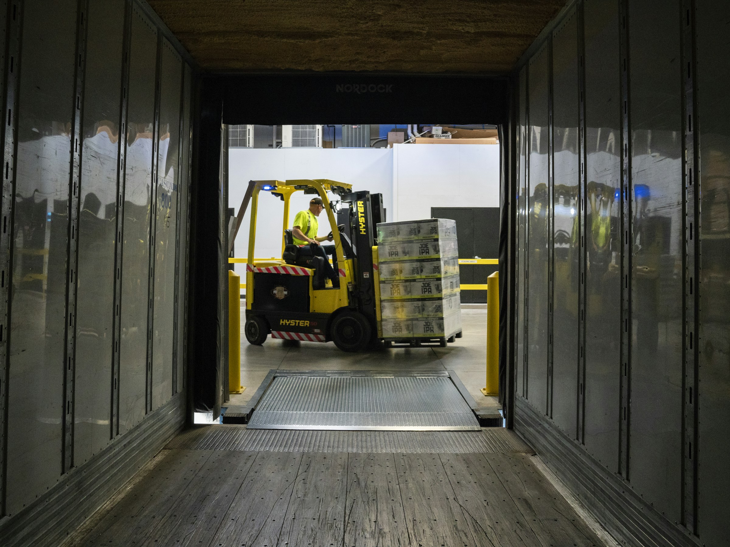 Goods being loaded onto a delivery vehicle at a distribution warehouse