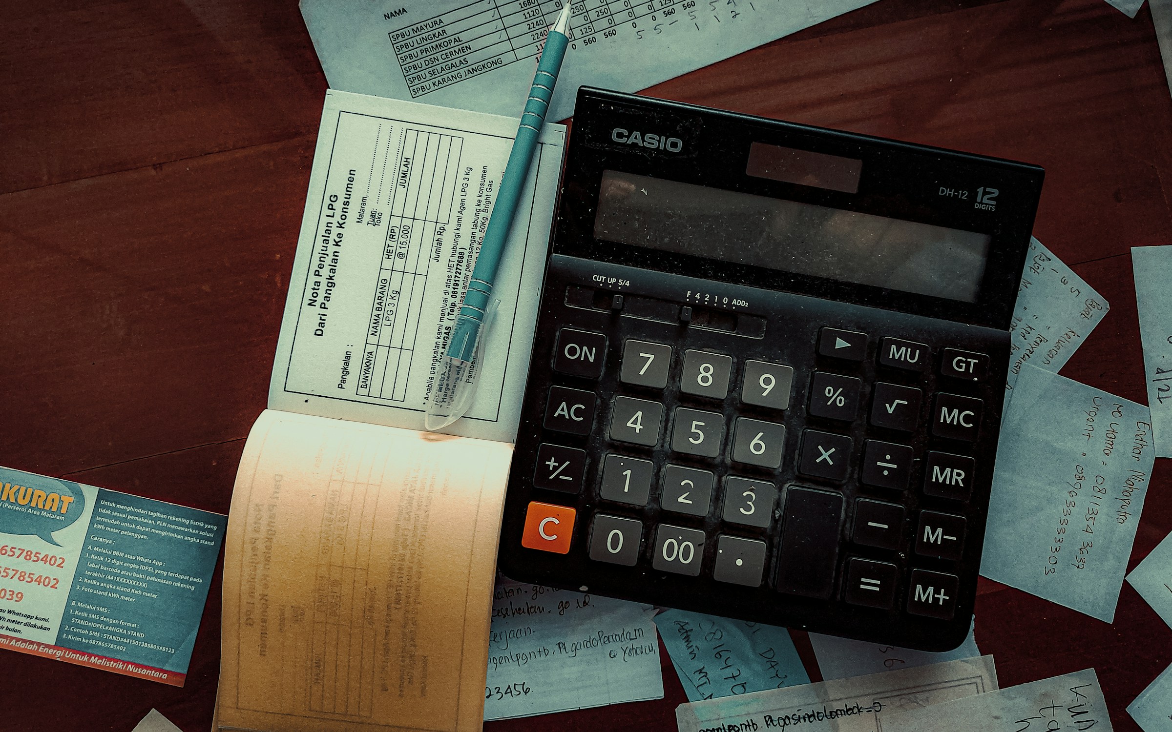 Paper ledgers, invoice books and a calculator on a trading office desk